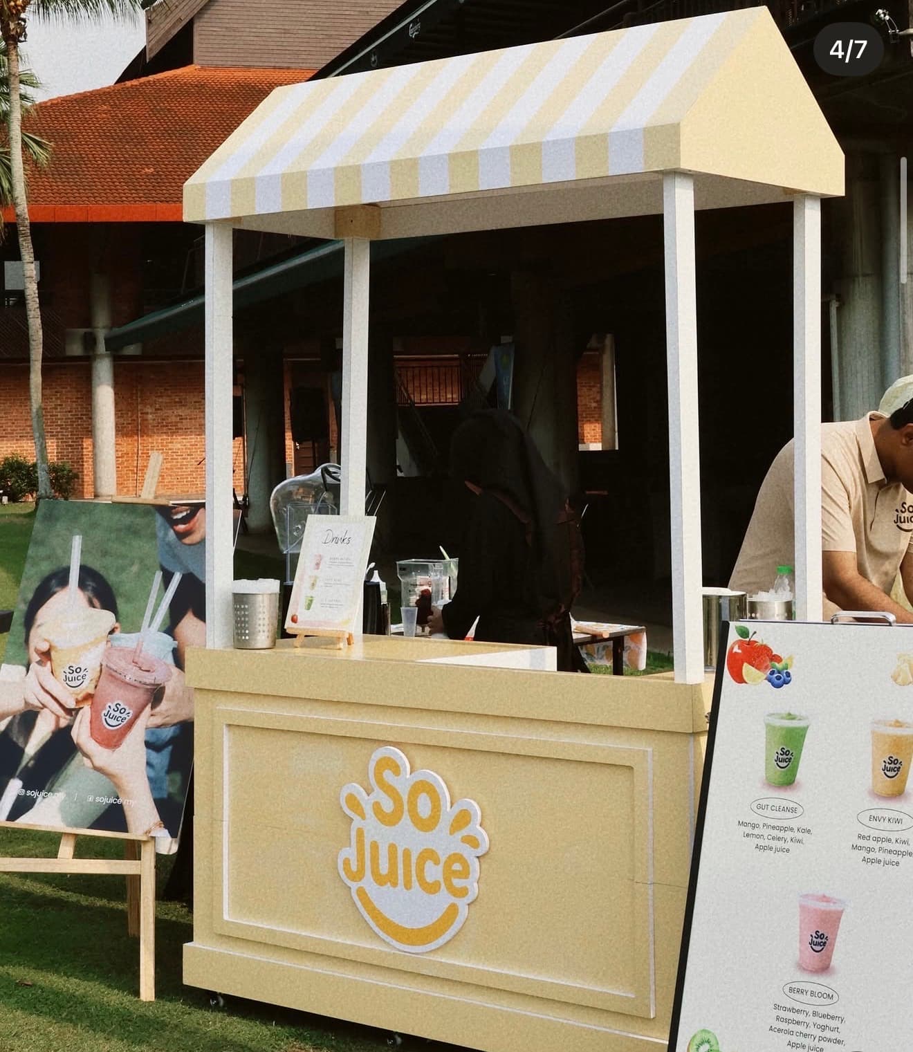 The SoJuice striped events cart set up on a lawn